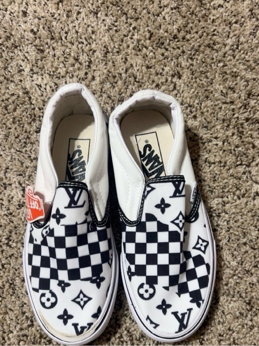Vans women’s white and Black Checkerboard Slip-On Sneakers